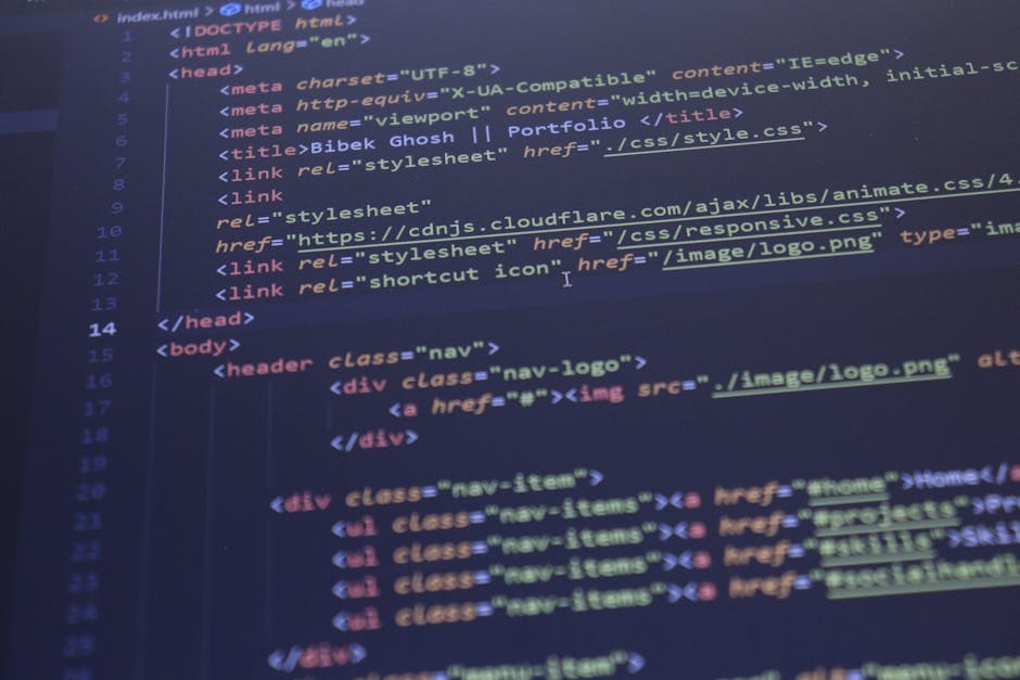 A photograph of a computer screen displaying lines of HTML code in a text editor with a dark background and multicolored syntax highlighting. The code includes tags such as <!DOCTYPE html>, <